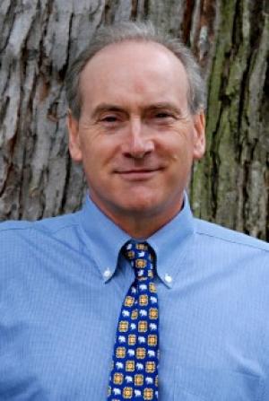 John McNeill in front of a tree.