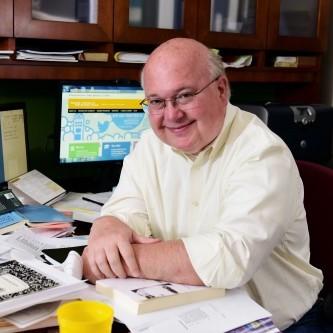 Gordon Kingsley sitting at a desk.