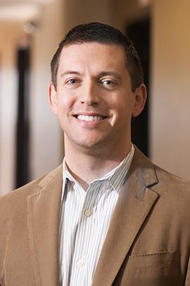 A portrait photo of Aaron Levine, associate professor in the School of Public Policy