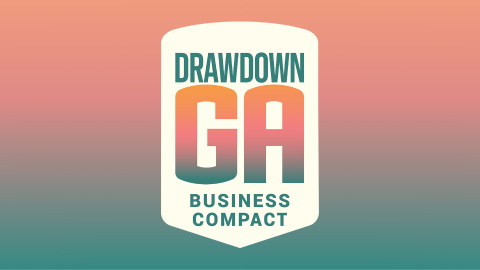 Drawdown Georgia logo with "business compact" underneath. Logo is set against a peach-to-green gradient background.