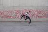 360 flip by Shan Suen and kickflip by Chris Metz in front of MACBA mural in Barcelona 