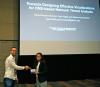photo of Rosa Romero-Gomez accepting best paper award at IEEE VizSec 2017
