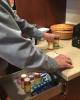 Patient stands at drawer with medications.